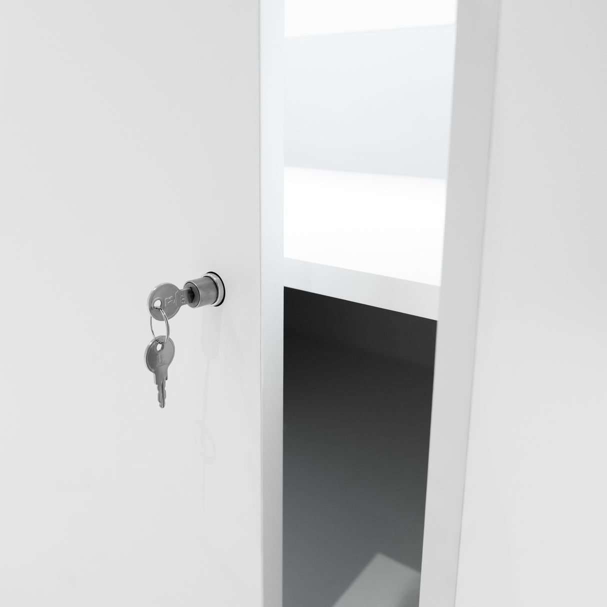 Chiave inserita in una serratura di un bancone da negozio LED B900 bianco, con ripiano interno visibile e design moderno e minimalista
