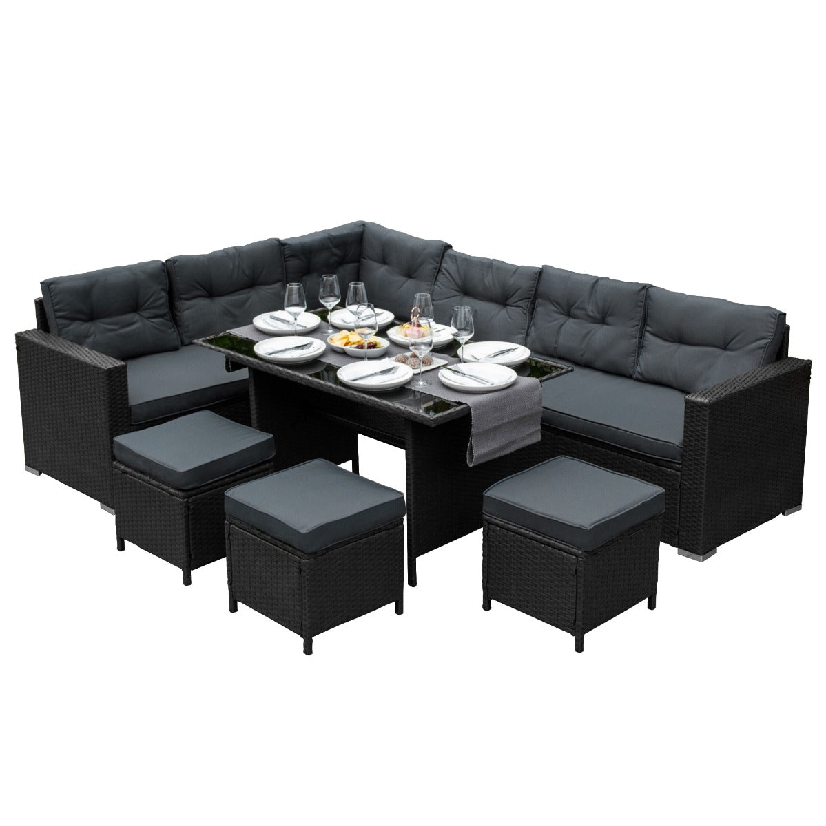 Set ad angolo in rattan nero con cuscini grigi, tavolo in vetro, ideale per pranzi all'aperto e momenti di relax in giardino