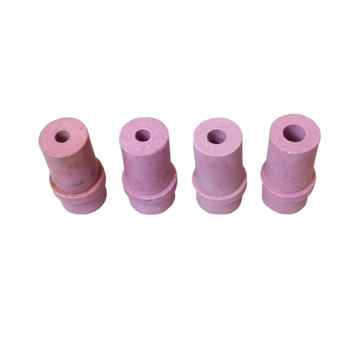 Quattro ugelli in ceramica rosa per cabina sabbiatrice, con forma cilindrica e superficie liscia, ideali per sabbiatura efficace