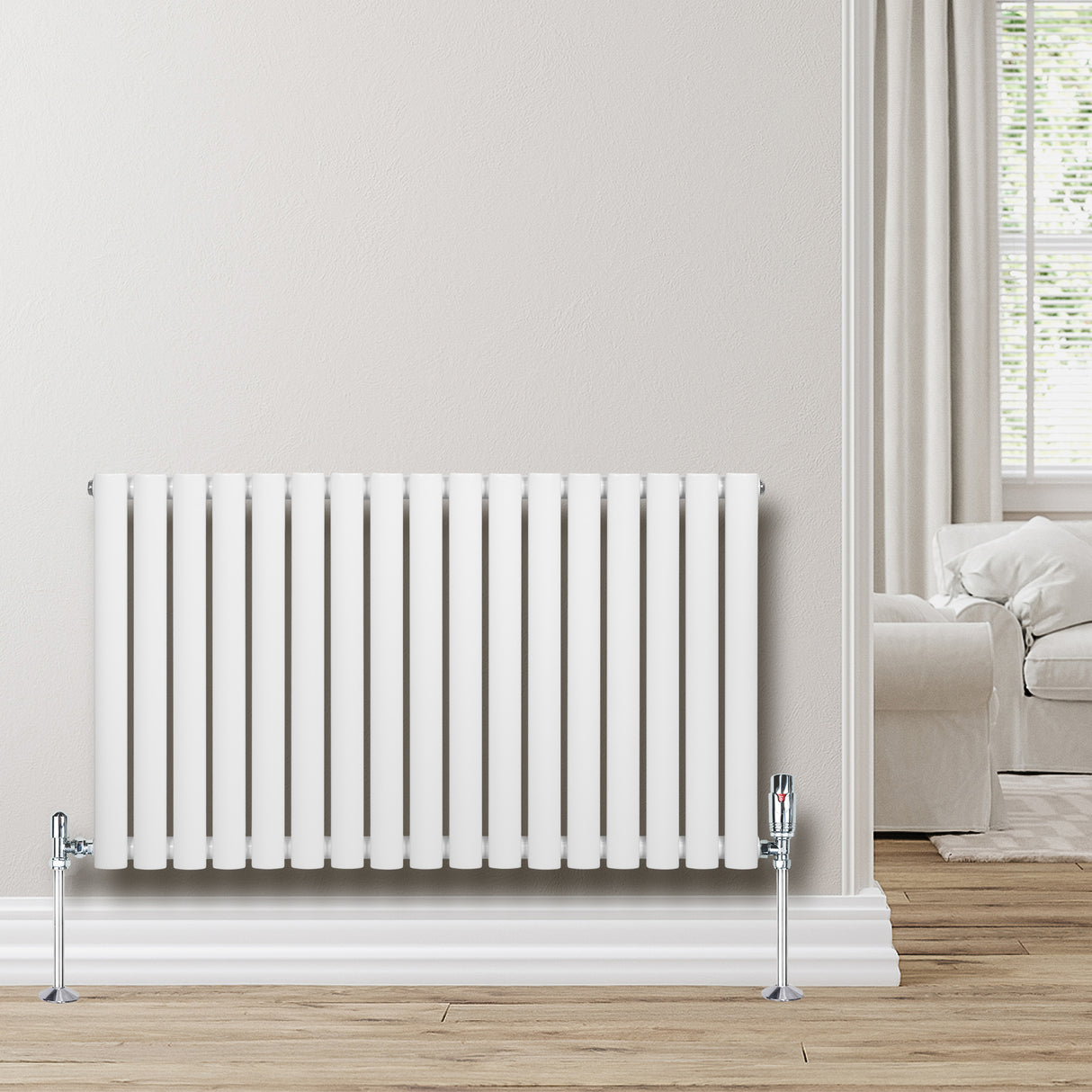 Radiatore ovale a colonna singola orizzontale bianco, con finitura liscia e valvole, posizionato su una parete chiara in un ambiente moderno