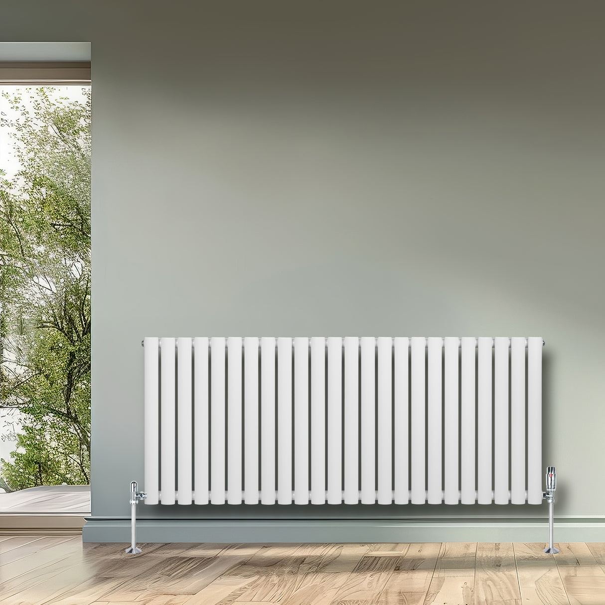 Radiatore ovale a colonna singola orizzontale bianco, con finitura liscia e valvole, installato su parete grigia in ambiente luminoso