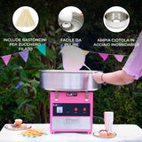 Macchina per zucchero filato KuKò, color rosa, con ciotola in acciaio inox e bastoncini inclusi, su sfondo festivo all'aperto