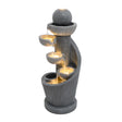 Fontana d'acqua elettrica in stile moderno, con finitura grigia, quattro vasche a spirale e luce calda che illumina l'acqua che scorre