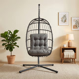 Poltrona sospesa a uovo in rattan nero con struttura metallica, cuscino grigio, design moderno e accogliente per interni ed esterni