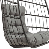 Poltrona sospesa a uovo in rattan nero con cuscino grigio, struttura in metallo, design moderno e accogliente per interni ed esterni
