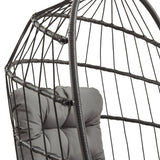 Poltrona sospesa a uovo in rattan nero con struttura metallica, cuscino grigio imbottito e design moderno e avvolgente