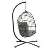 Poltrona sospesa a uovo in rattan grigio con struttura nera, cuscino morbido e design moderno, ideale per interni ed esterni
