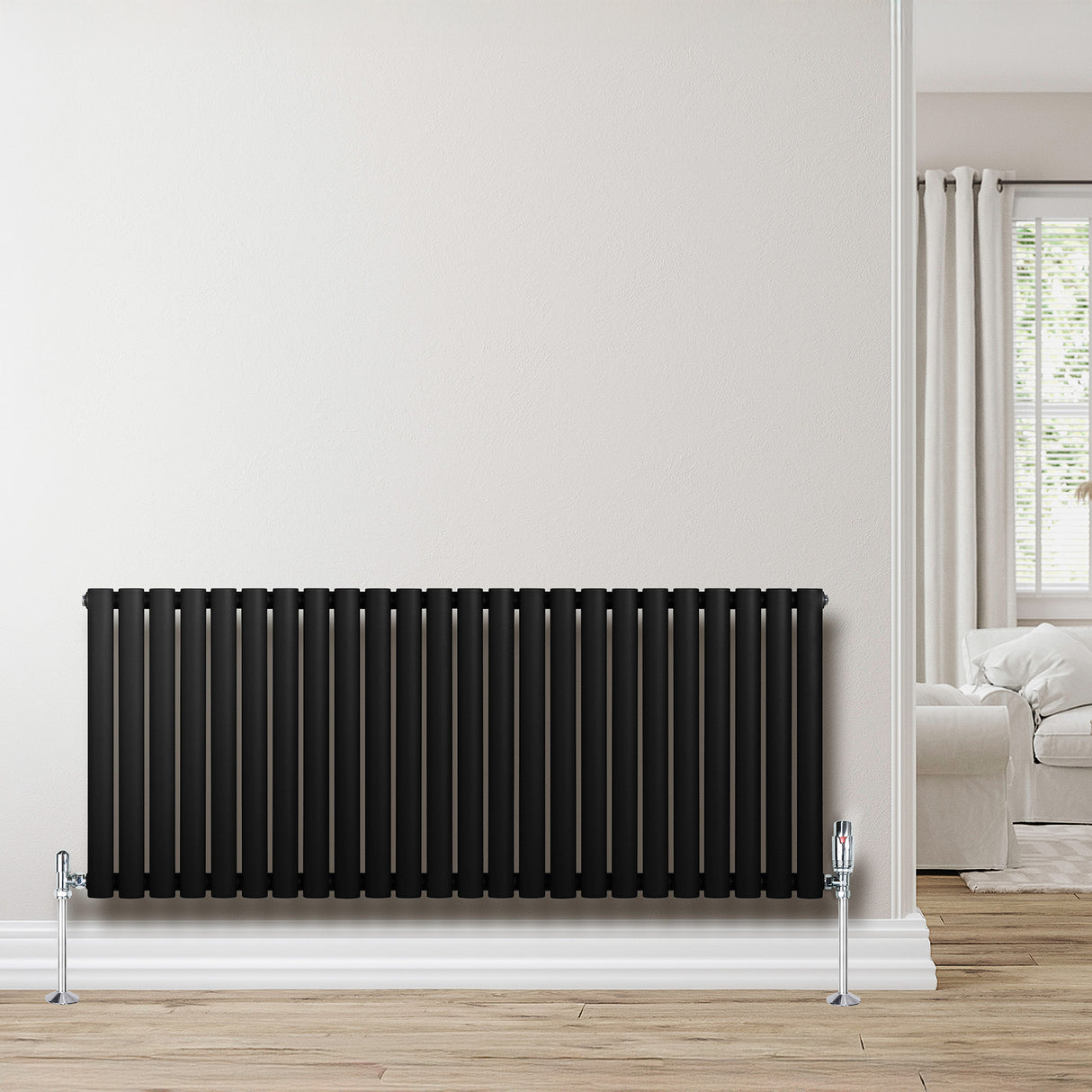 Radiatore ovale a colonna singola orizzontale, 600 x 1440 mm, finitura nera opaca, con valvole cromate, elegante e moderno