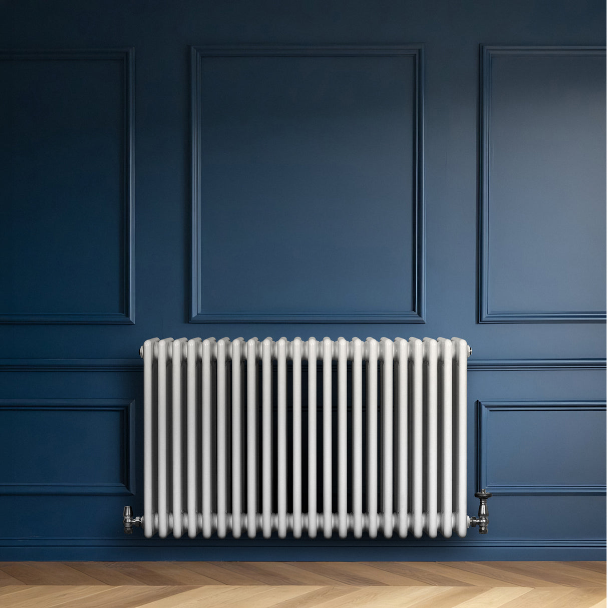 Radiatore tradizionale a 4 colonne orizzontali, bianco, installato su una parete blu, con finitura liscia e tubi rotondi