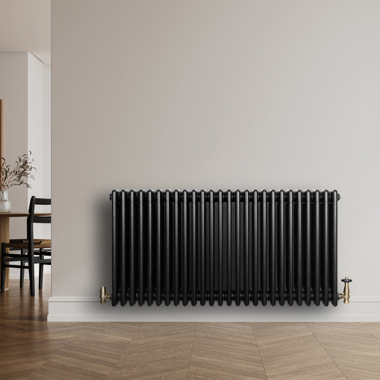 Radiatore tradizionale a 4 colonne orizzontali, 600 x 1190 mm, finitura nera lucida, installato su parete chiara in ambiente moderno